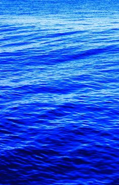 This may contain: the water is very blue and there are no waves